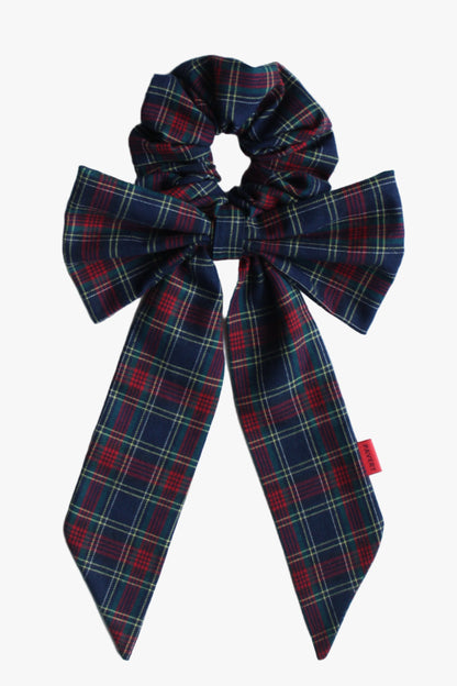 Plaid bow scrunchie on a light blue background